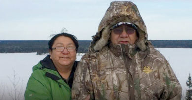 Photo of Larry and Elizabeth Beardy in casual winterwear with a winter landscape in the background