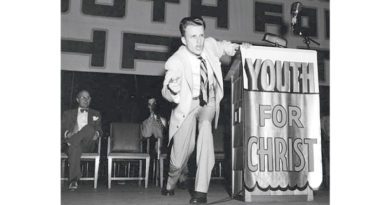 Billy Graham as a young evangelist preaching on a platform with a podium that says "Youth for Christ"